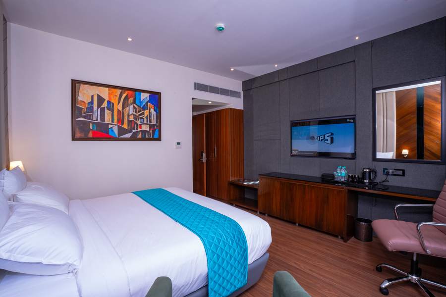 Executive room at Hotel Paramos Meeds Madiwala with king bed and modern interiors