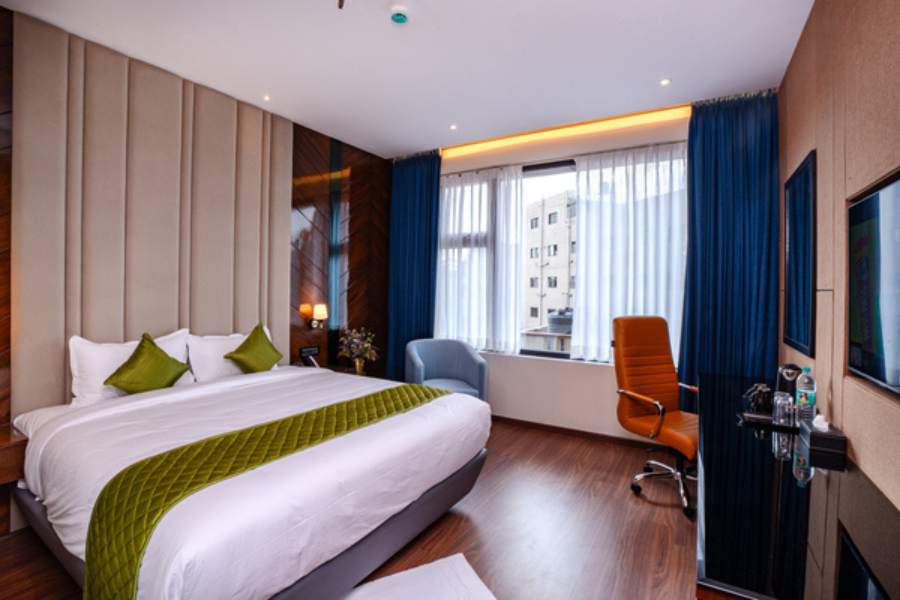 Premium room at Hotel Paramos Meeds near BTM Layout featuring spacious interiors